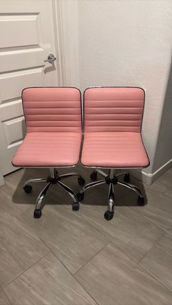 2 pink rolling chairs