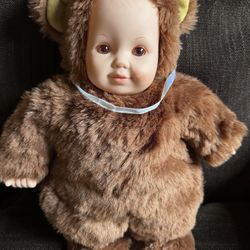  1997 UNIMAX Anne Geddes 15" baby doll with beautiful brown eyes in good condition has a little red mark on cheek. Stamped on the back of her neck 199