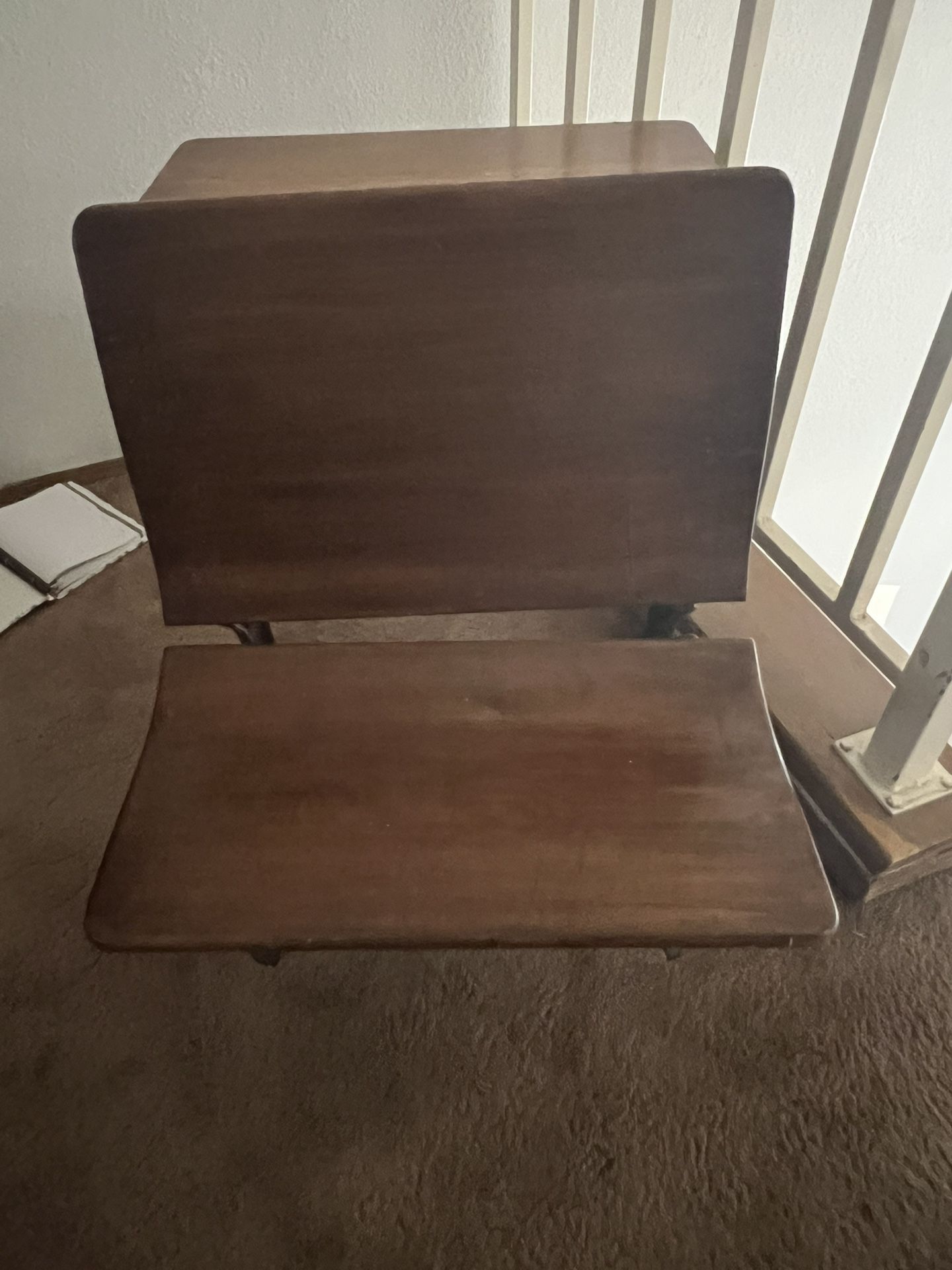 This is an antique wooden school desk with a cast iron base. 