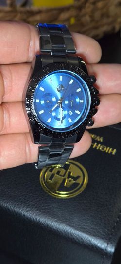 AJ Luxury  Watch with Blue Dial and Black Stainless Steel Band.
