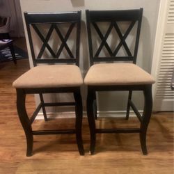 Set of 2 counter-height stools. These feature a classic Double X-back design with an espresso wood finish and neutral beige upholstered seats.  Style: