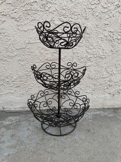 Princess House Meridian Three-Tiered Metal Basket featuring a dark brown or black scrolling wire design with three graduated bowl tiers.