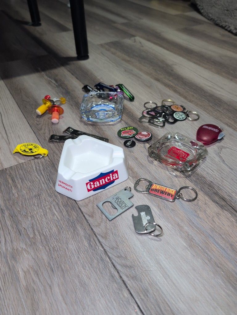 3 Ashtrays And Several Bottle Openers