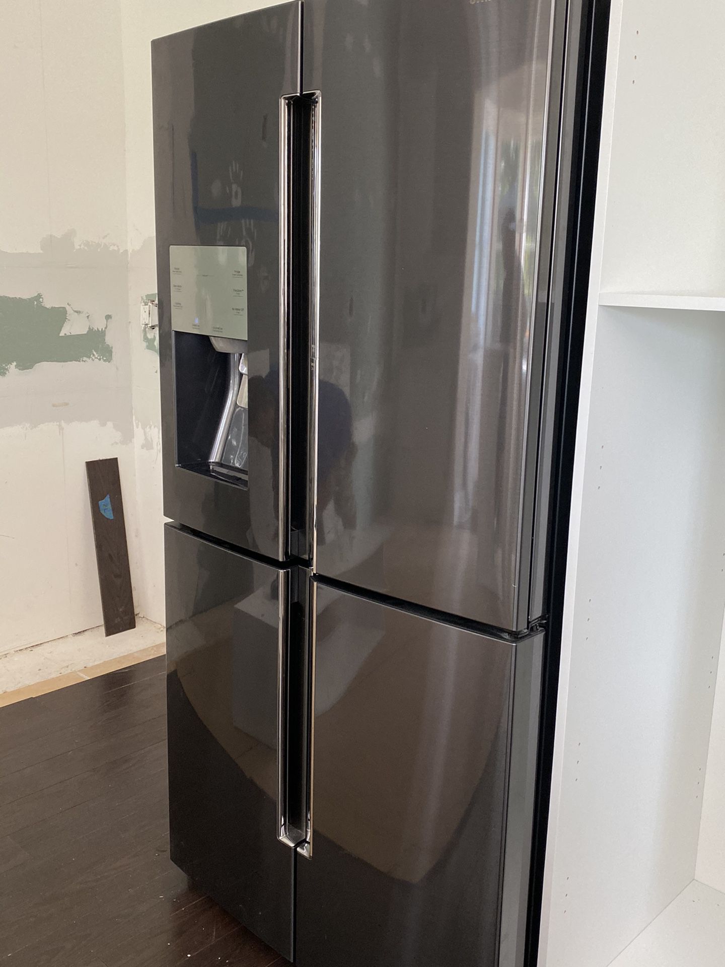 Samsung like new black stainless refrigerator with five year warranty.