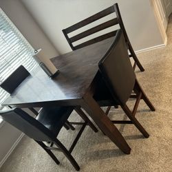 Adjustable  Dark wooden table w/ 3 chairs and a bench 