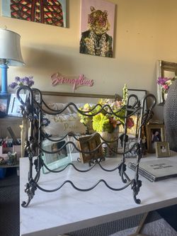 Iron wine rack with grape leaves