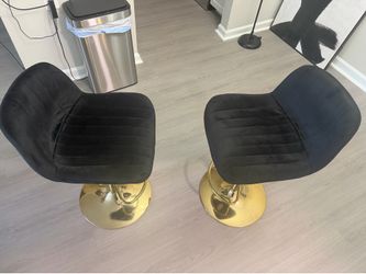Pair of black and gold Bar stools .