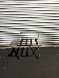 Stainless steel folding luggage rack with a backrest and black nylon