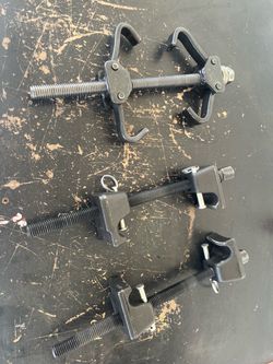 Coil spring compressors
