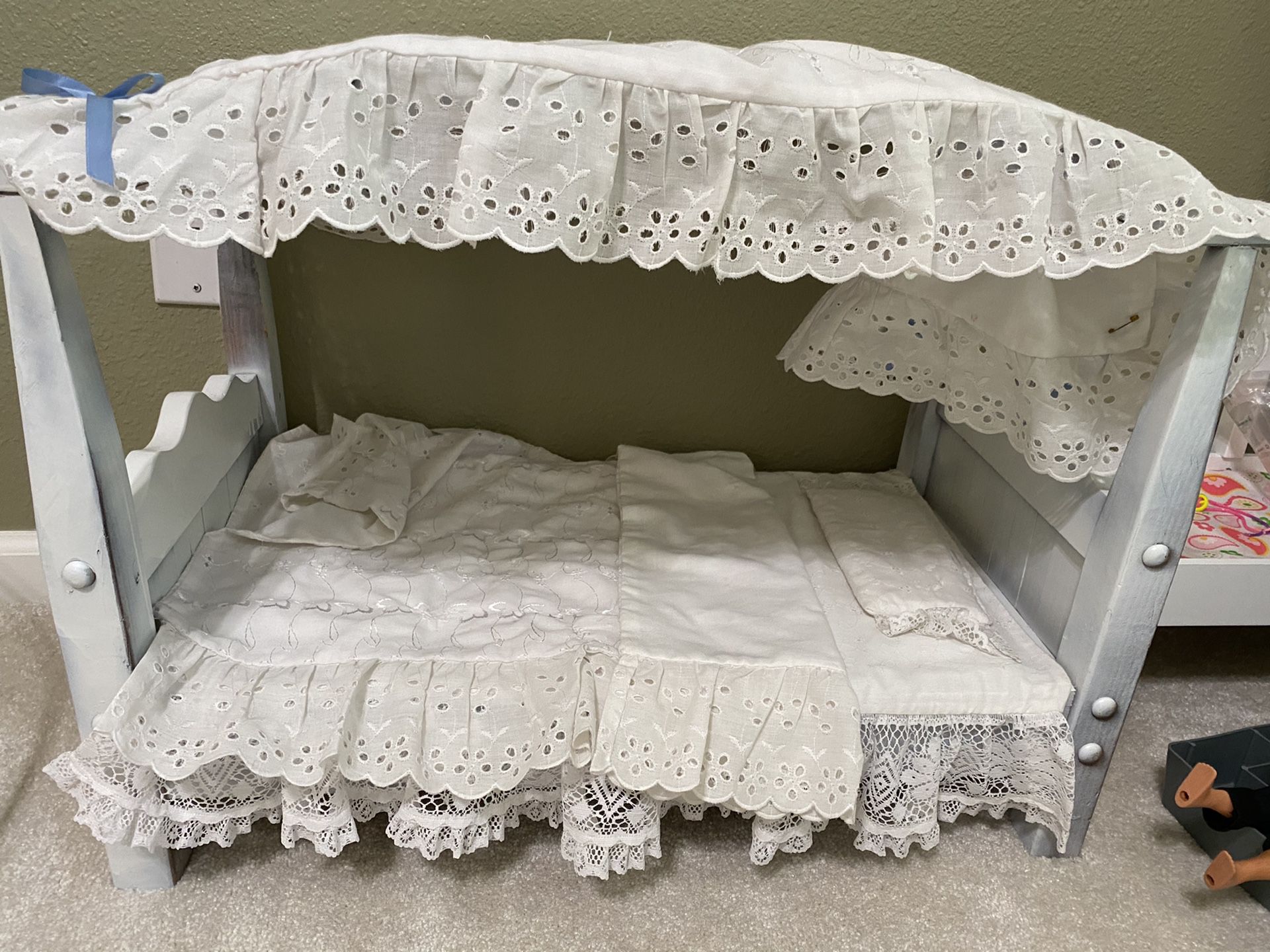Wooden hand crafted canopy doll bed with linens