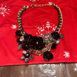 black flower bib statement necklace with gold-toned chains and beaded accents