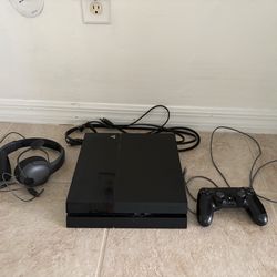 PS4 with controller and headset