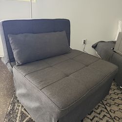 Grey chair that pulls out into bed