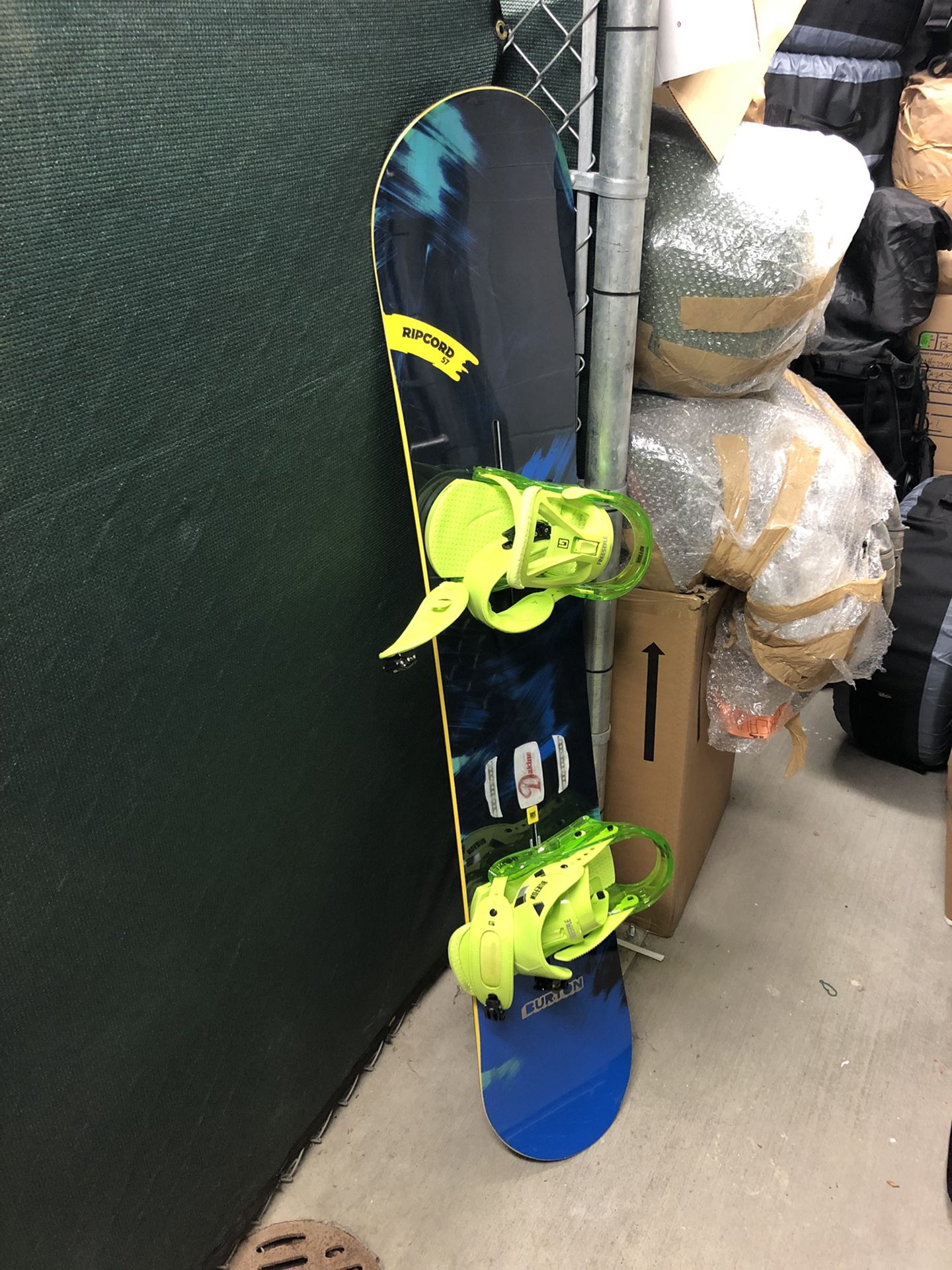 Snowboard, bindings, helmet, and bag
