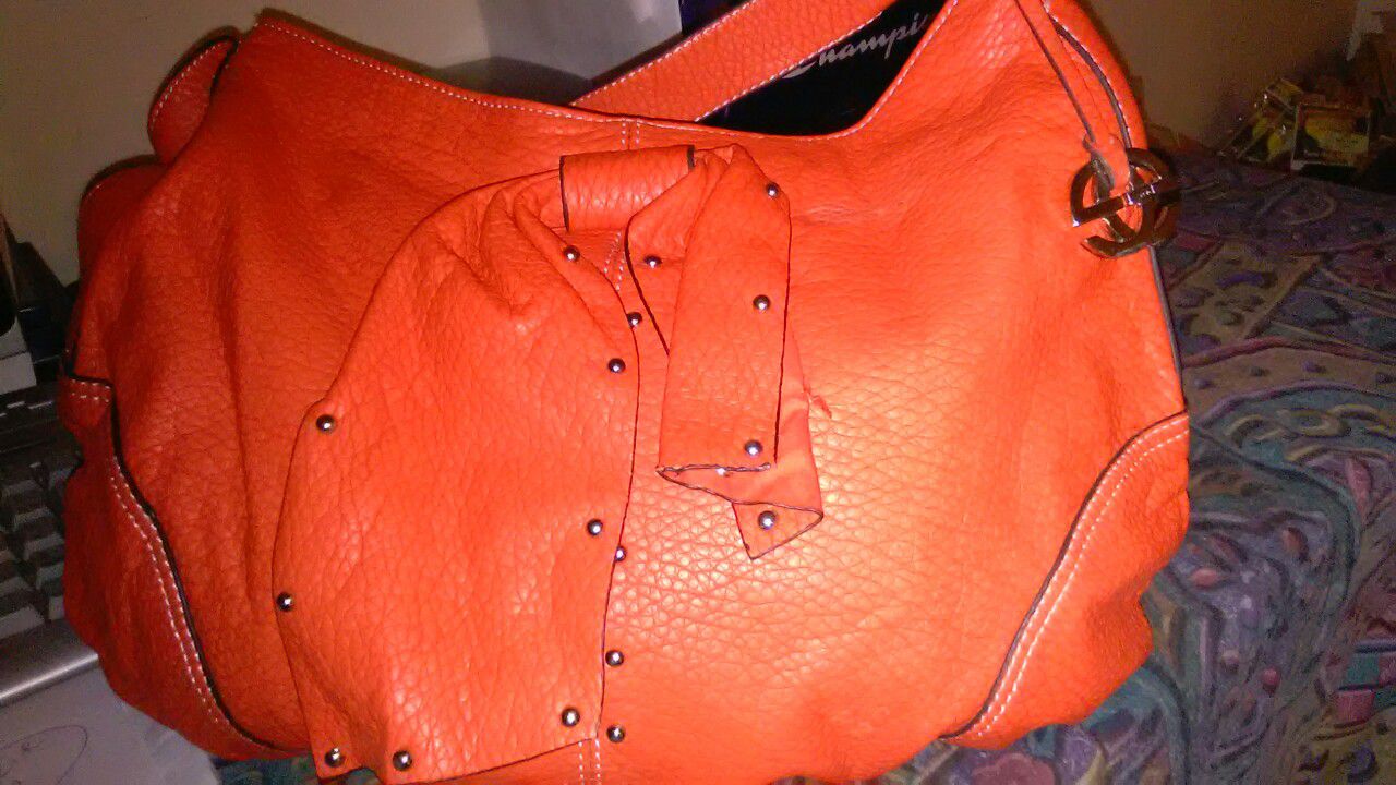 Orange leather purse. Used but very clean inside and out.