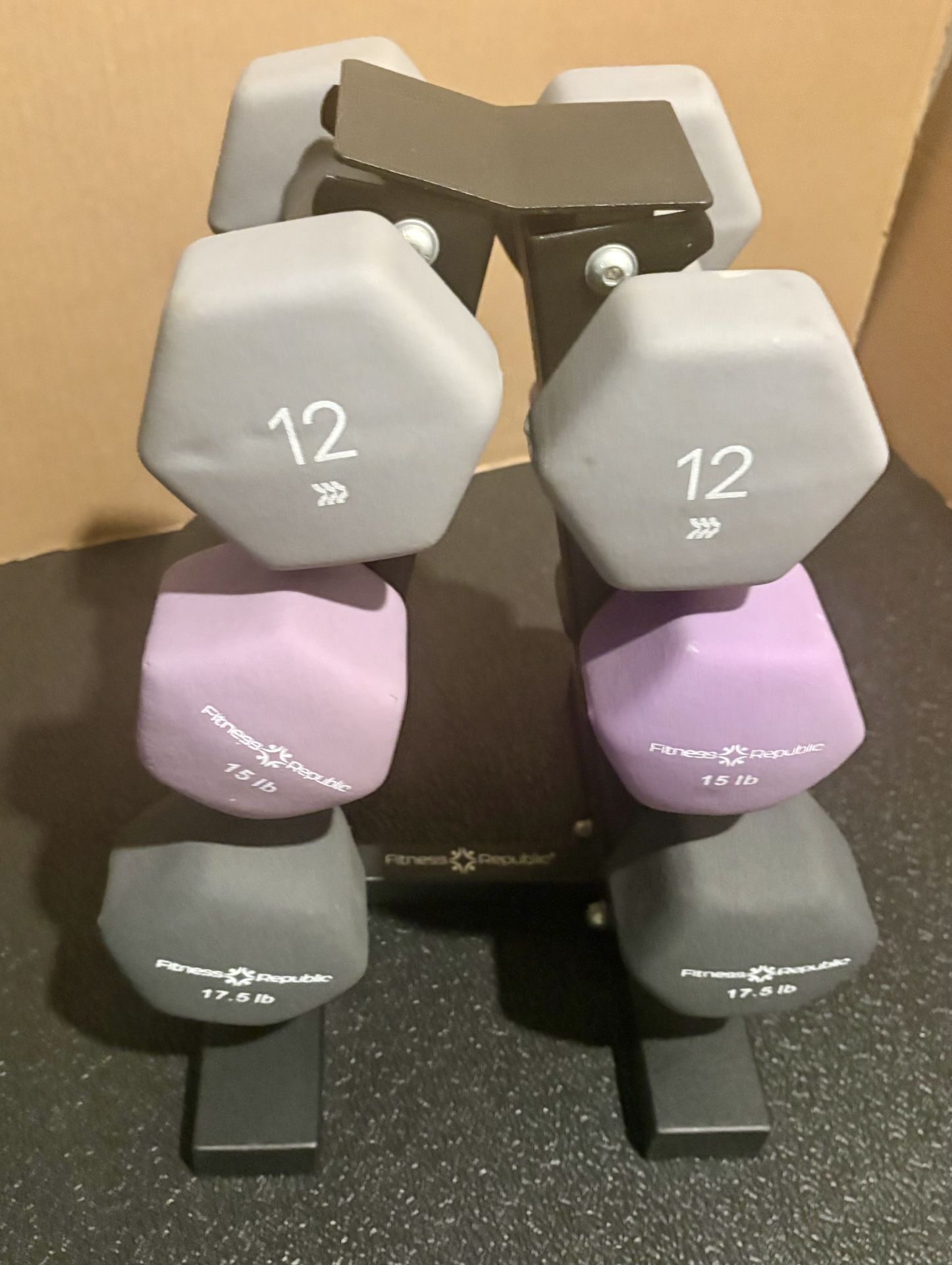 Cast Iron Neoprene Coat ...Set of Dumbbells with Rack; pairs of 12s, 15s and 17.5 lbs.