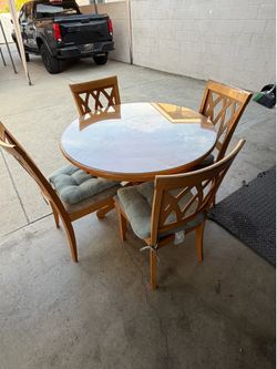 round wooden table with glass top 4 chairs included