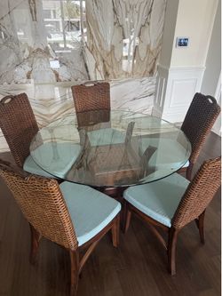 Braxton Culler Boone dining set features a 60-inch round glass top table paired with four high-backed rattan chairs - Excellent condition