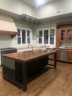 Large black industrial-style pot rack chandelier.