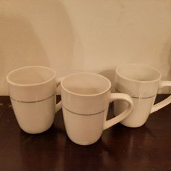 3 white cups with silver trim. Emerald brand.
