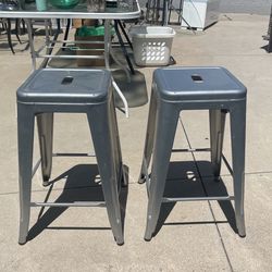 A pair of metal barstools