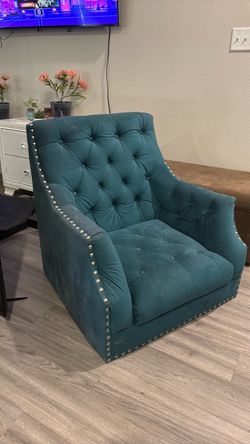 Green chair with brass nailheads