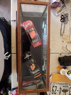 Car number 8 and car number 3 in a glass and wooden box.