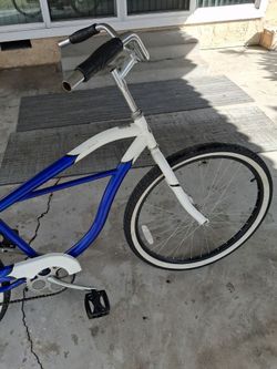 SchwInn legacy beach cruiser. Blue and white frame, 26 inch wheels.