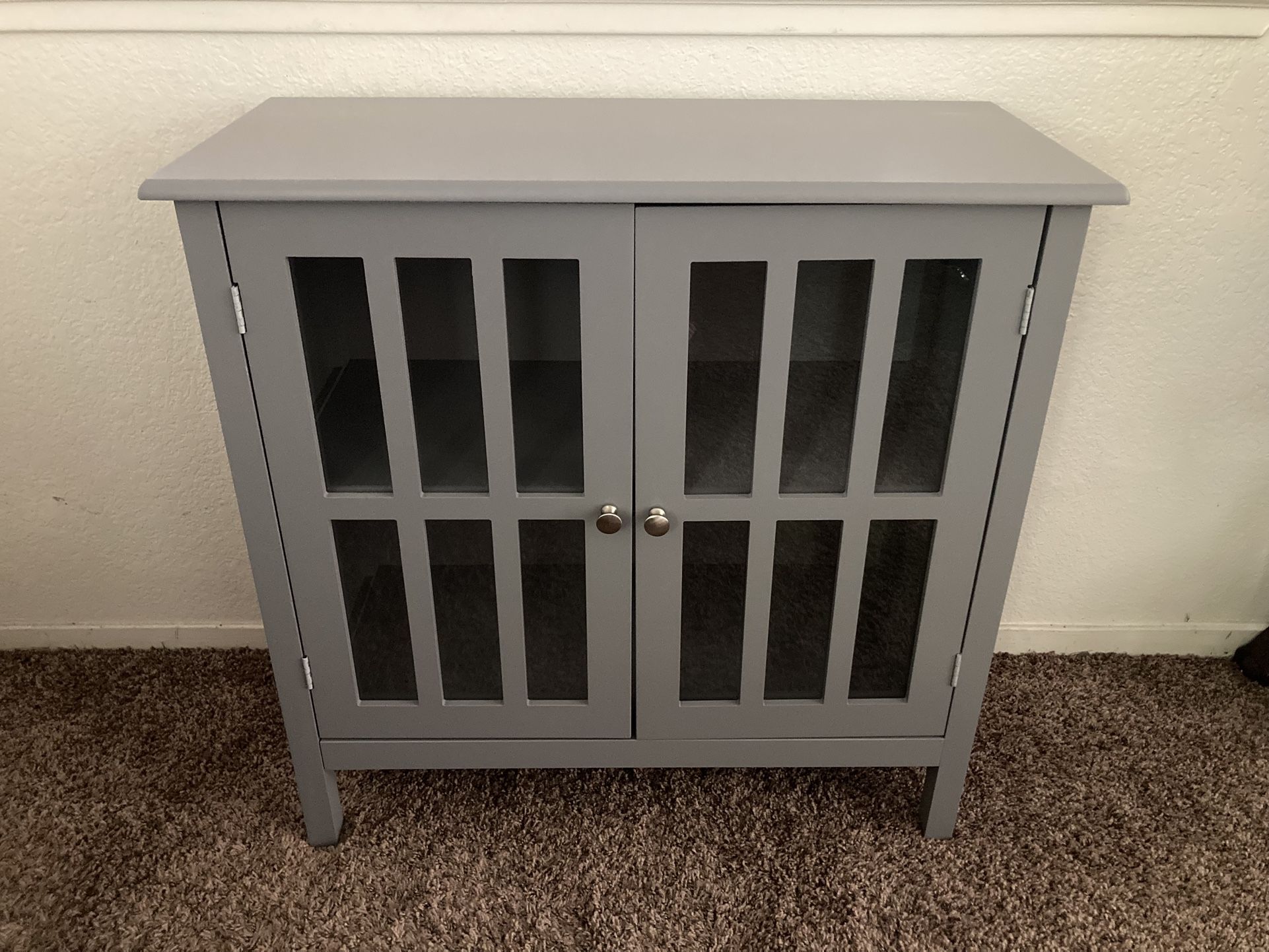 Gray Cabinet With Shelves And Windows