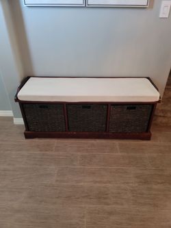 Padded bench with wicker storage bins baskets