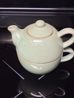 Tea pot on top of teacup