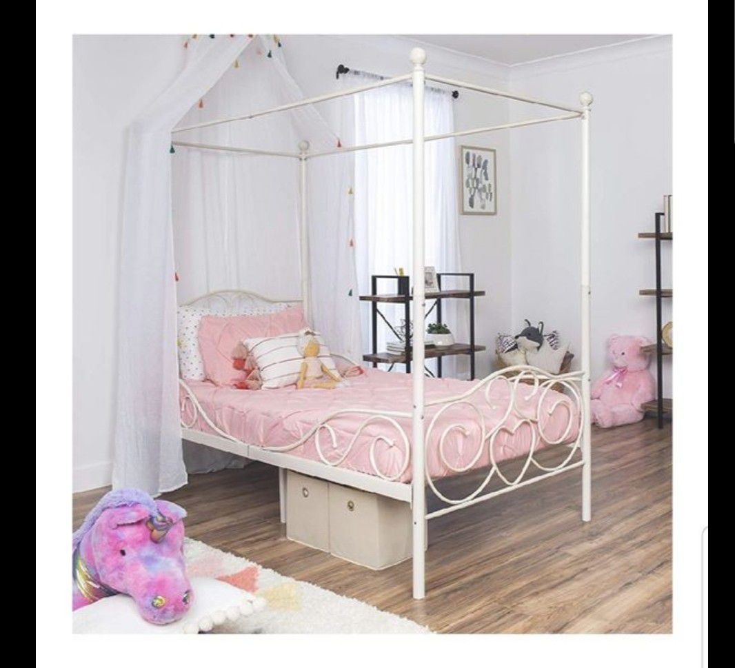 Twin size heart detail white metal canopy bed. Mattress not included.