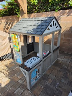 KidKraft Patio Party Wooden Outdoor Playhouse with Spinner Block Puzzle