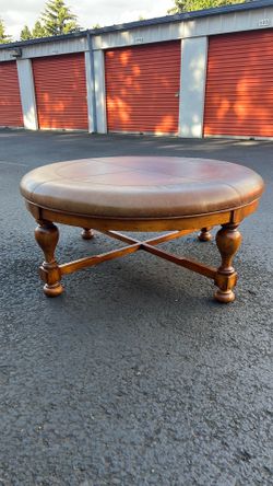 Huge beautiful tufted real brown leather round ottoman coffee table with a wooden base