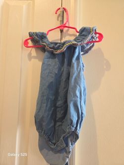 baby girl blue denim onesie with shoulder ruffles