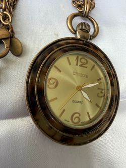 It is a Chico’s pocket watch