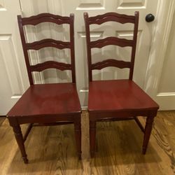 2 red wood dining table chairs