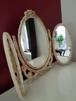 Antique tri fold mirror. Made in Italy. Hand carved with little flowers around. Felt backing.