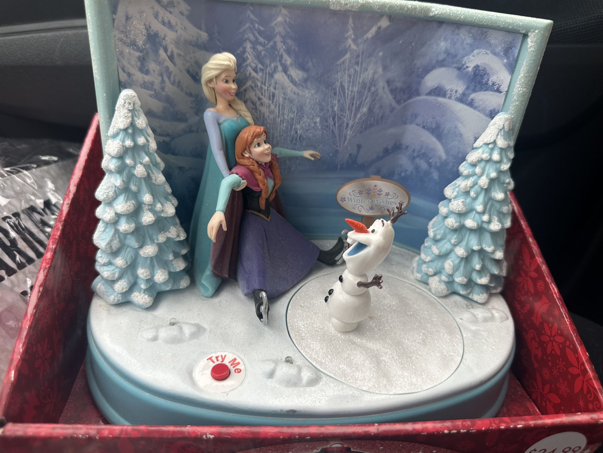 Disney Frozen musical figurine featuring Elsa, Anna, and Olaf.