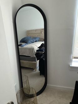 Black oval mirror