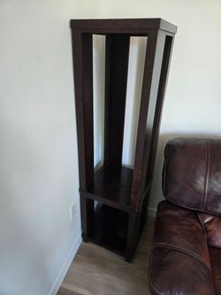 Tall dark wood display shelf