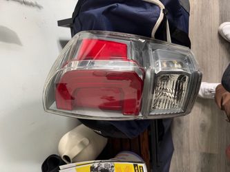 Black plastic front lower valance spoiler and right side tail light for a Toyota Tacoma truck