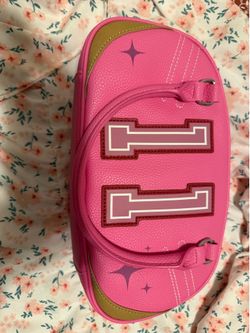 Paris Hilton pink varsity bowler bag featuring a prominent number 11 design
