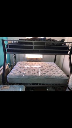 Metal bunk bed with mattress.