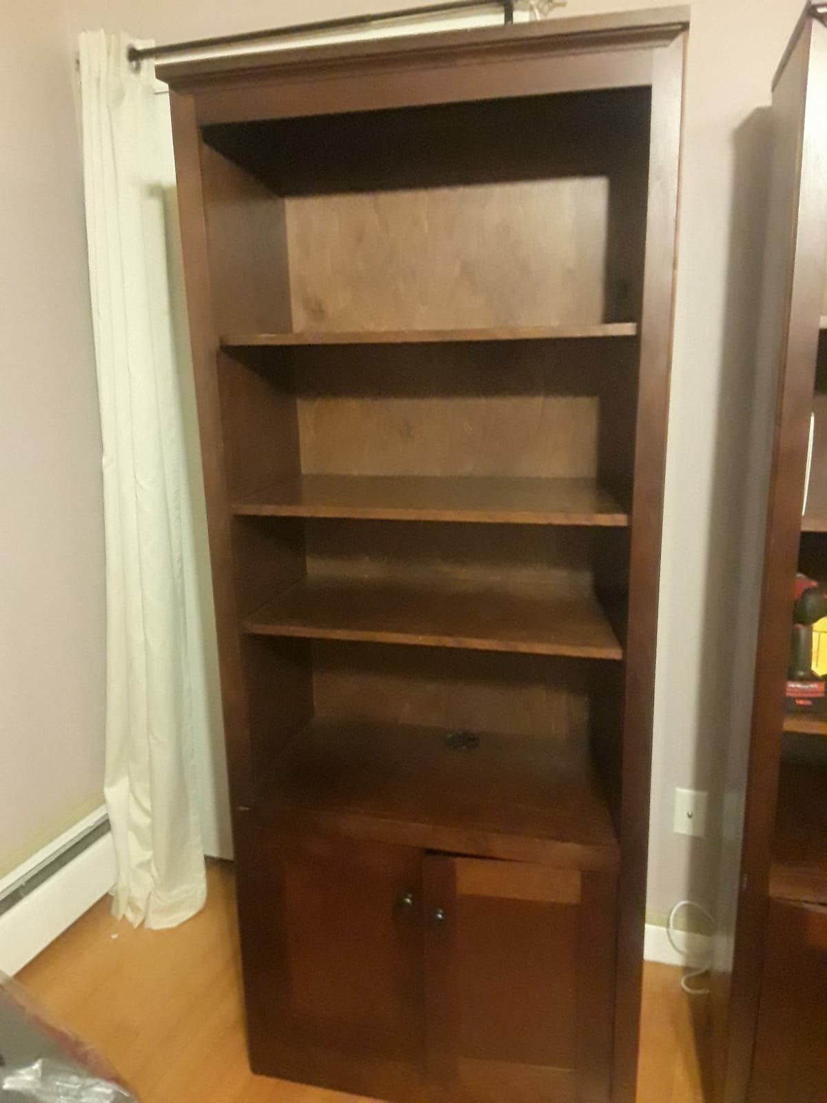 Two wooden bookshelves with cabinets