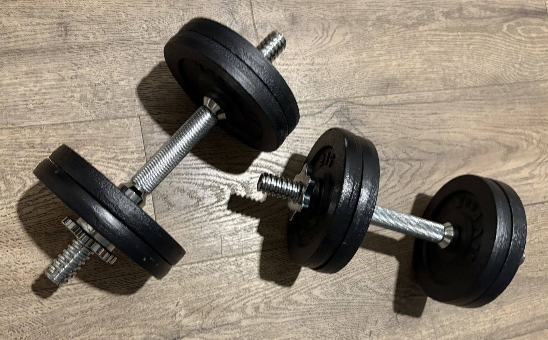 Set Of Cast Iron Adjustable Dumbbells 25 lbs Each.