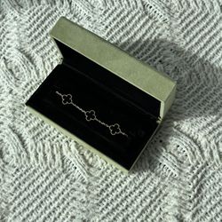 Van Cleef & Arpels Vintage Alhambra bracelet in black w/ gold.