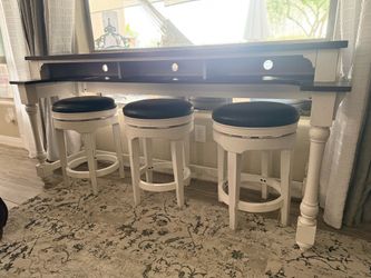 Behind couch table and stools
