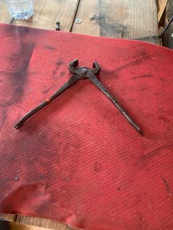 vintage farrier's nipper or a blacksmith's nail puller, often referred to as claw pliers or pincers.