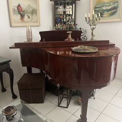 Pearl River baby grand Piano Shiny Burgundy. Exterior Perfect Condition. Needs Small Work Done . Bench Storage Included